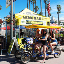 Load image into Gallery viewer, Pedal Limousine with girls riding by the Lemonade stand.
