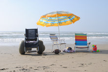 Load image into Gallery viewer, The coastline of Huntington Beach, straight out from Zack&#39;s by the Beach. A sand wheelchair for those with disabilities, beach chairs, an umbrella, football, beach towels, blanket, and sand castle toys.
